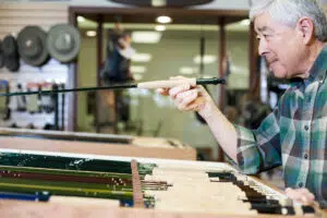 A Custom Builder Looking At a Fishing Rod Blank