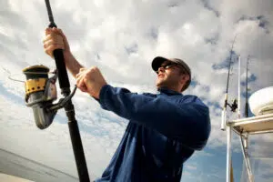 A Man Using Repaired Fishing Rod