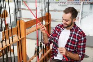 Man Shopping for Fishing accessories in Store